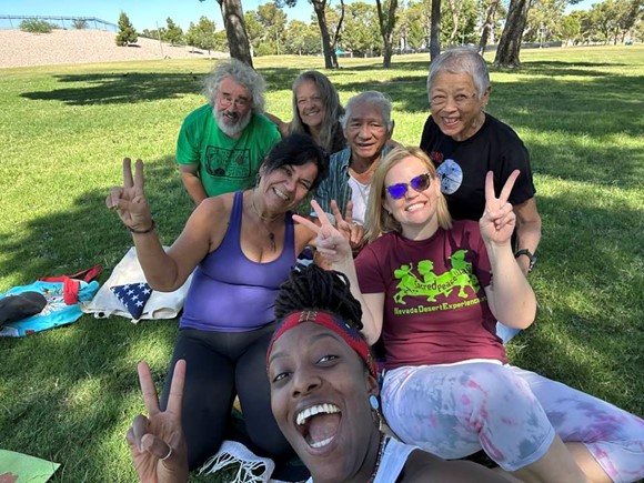 Yoga and Meditation group sitting on the grass in Craig Ranch Park in Las Vegas