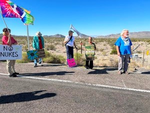 Protestors with flags and signs at Nevada Nuclear Security Site gate